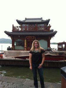 Kate Roth by a lakeside pagoda.