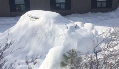 A car is covered in snow at the residence hall.  Photo by Cullen Taylor | The Broadside.