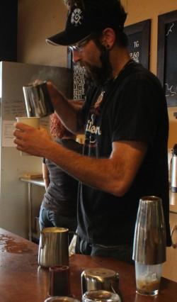 Derrick Strange, a student at COCC pouring a latte for a customer.  Photo by Vera Holiday | The Broadside.