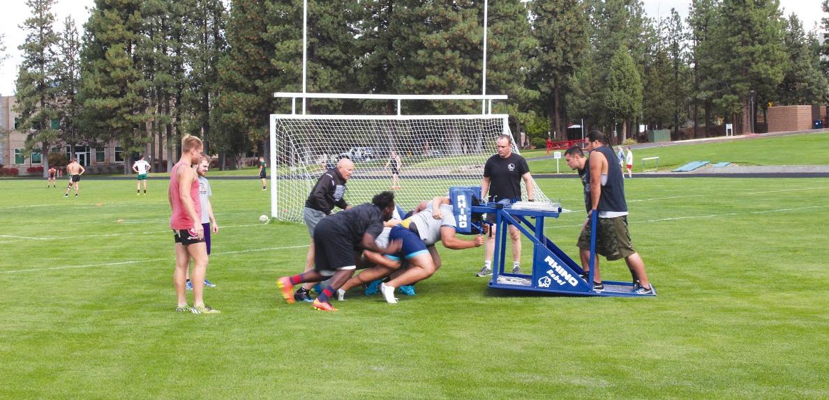 Bobcat forwards practice on the scrum machine.