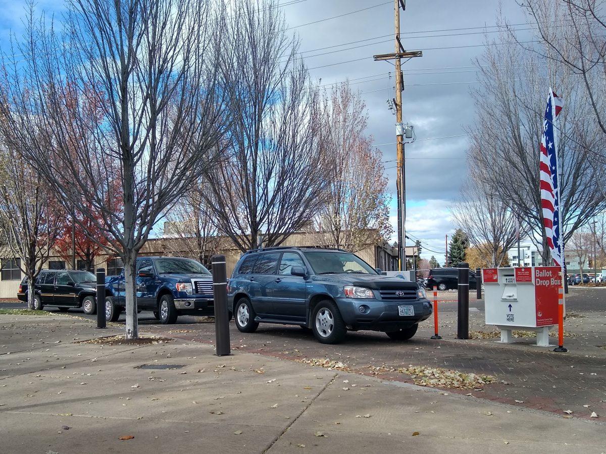 A line of cars waits to vote in the 2020 general election in Bend, Oregon, on a cloudy day downtown, onthings including ballot measures, presidential and local candidates, and taxes.