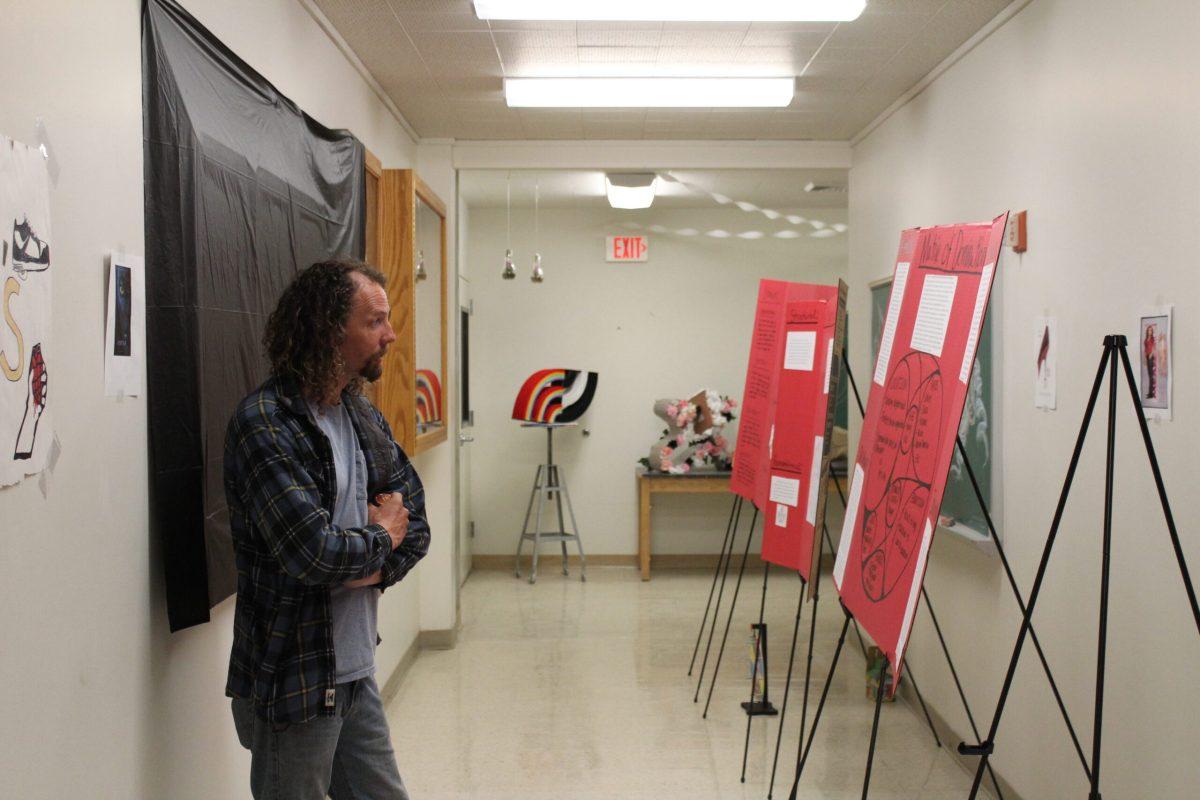 An attendee of the Student Showcase admiring student presentations. Photo by Mel Smith.