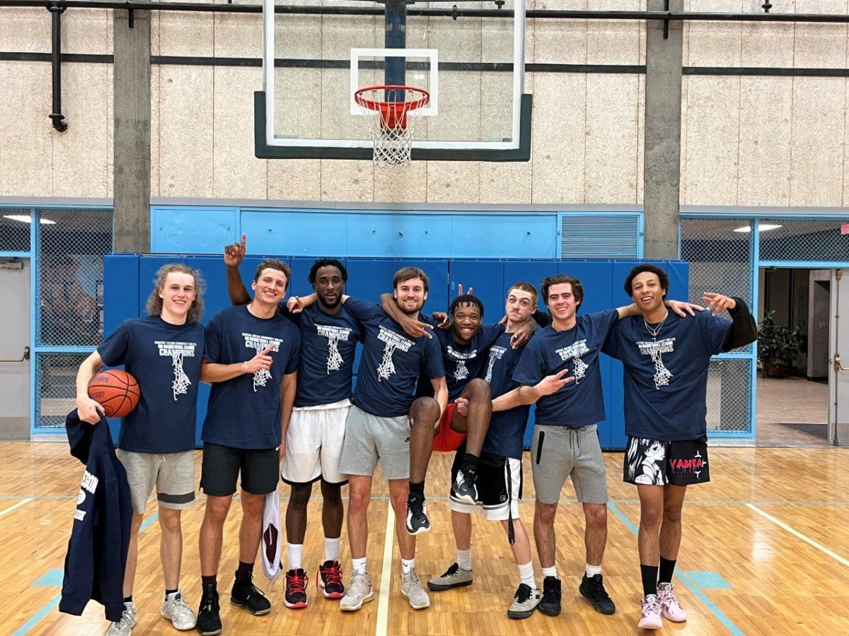 Team Couch finished a dominant season with a 69-61 championship victory over the defending champion Bucket Getters, and Kobe Knuckle (middle, being held up) was the hero in the final minutes. (Photo by Josh Motenko)