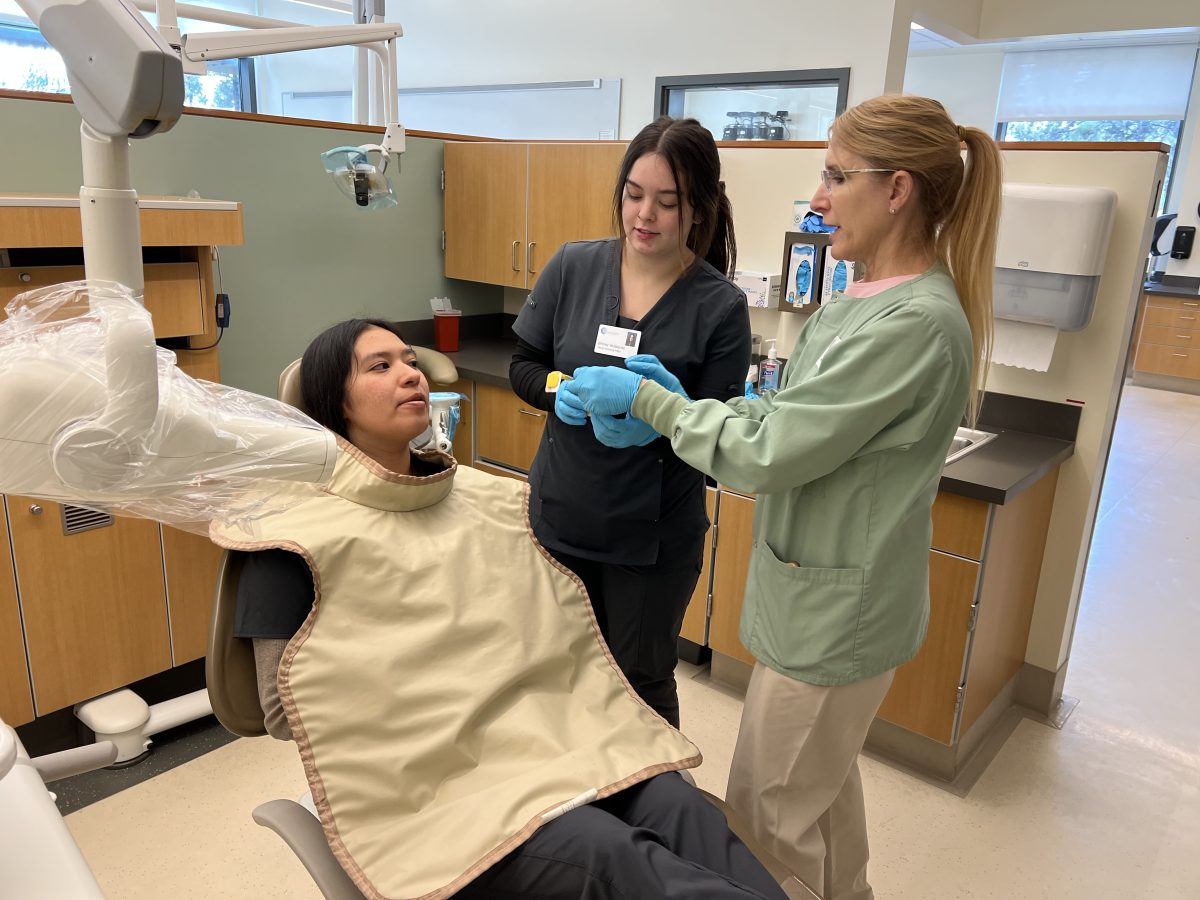 Professor Lynn Murray (right) teaches students Xochilt Ochoa (left) and Britney Velasquez (center) in COCCs Dental Program. (Photo by Hannah Evenson)