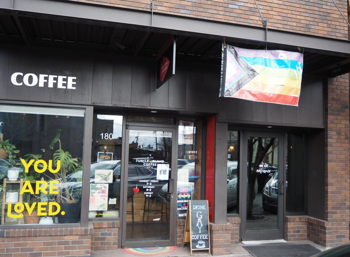 The outside of Turtle Island Coffee which has the pride flag up.