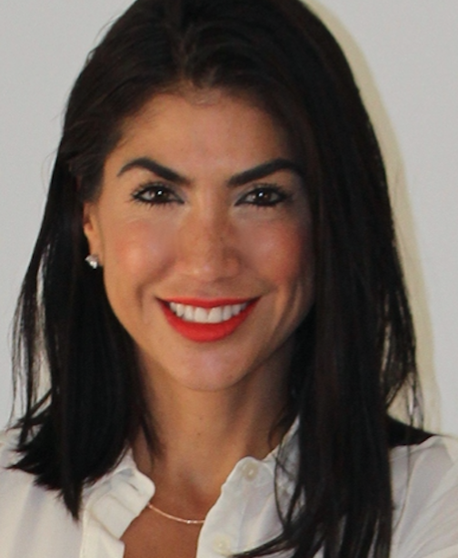 Portrait of a smiling Latina woman with dark hair, wearing a white collared shirt.