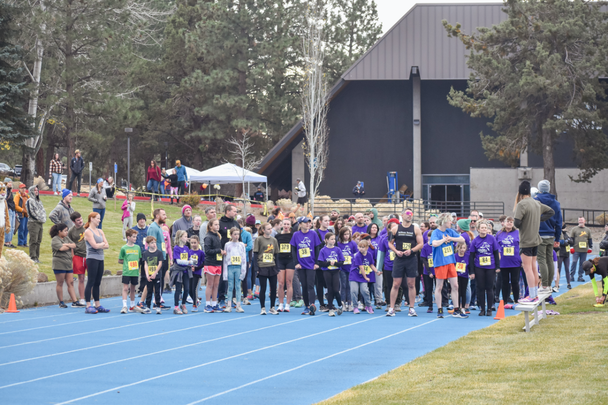 Runners gather at the start line and listen to the instructions for the race.