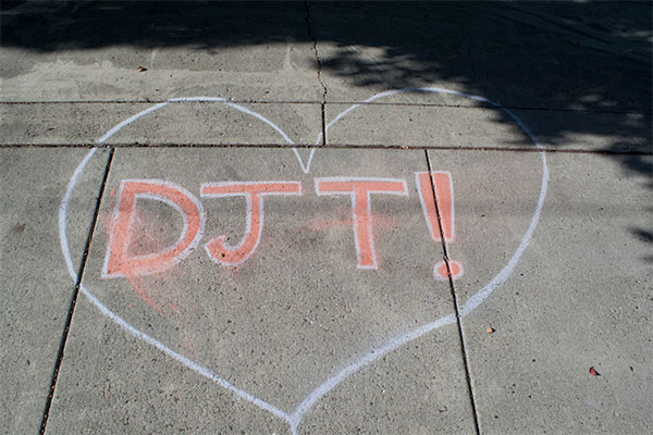 A Chalk illustration of a heart shape with the initials "DJT" (Donald J. Trump) inside of it, outside of Coats Campus Center in Bend, on Nov. 7 2024, near the crosswalk.