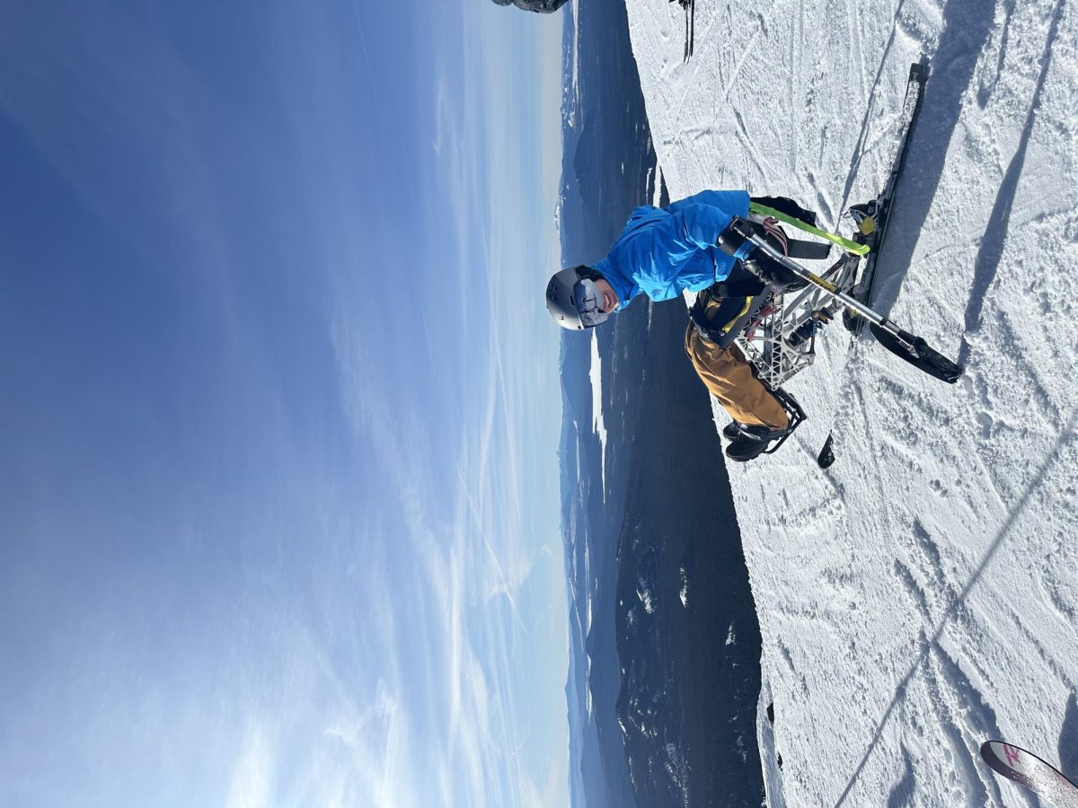 Kumlin looking out at the blue sky at the summit of Mt. Bachelor 
Photo curtesy of Adam Corazzi