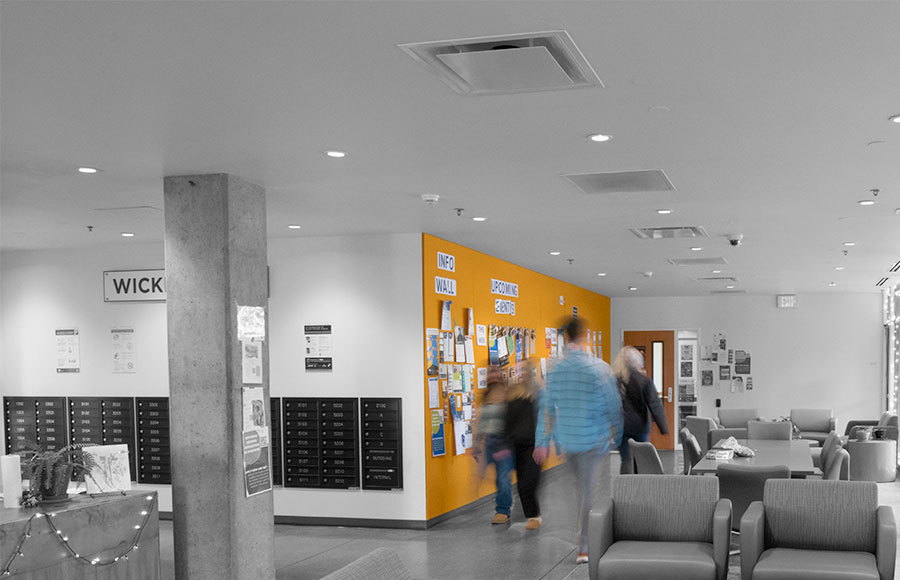 Students walk along Wickiup Hall's Information wall at Central Oregon Community College.